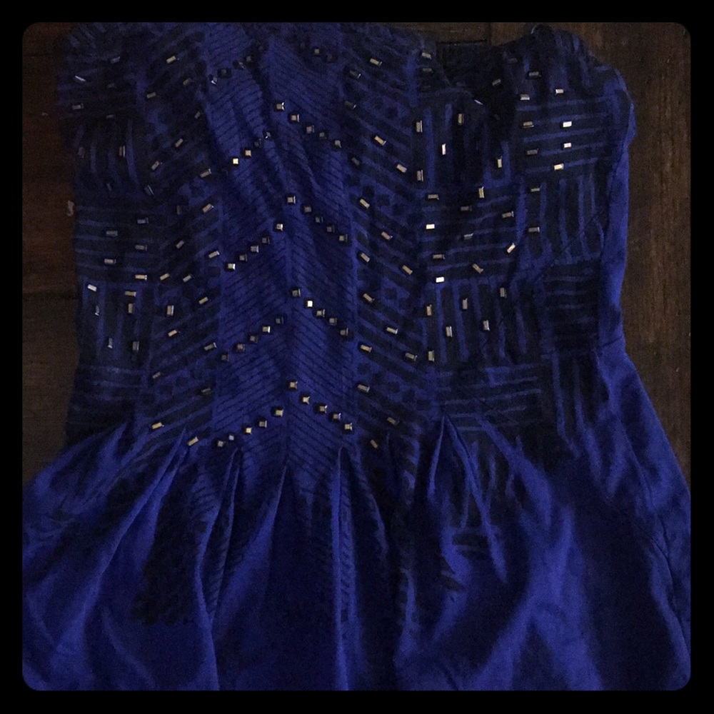 GUESS strapless top with front beading.